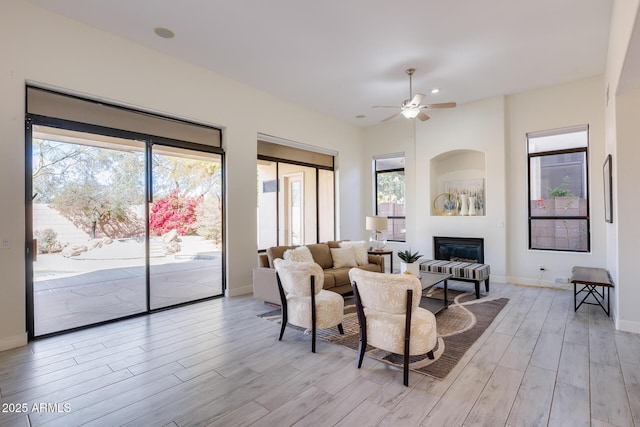 living room featuring ceiling fan and light hardwood / wood-style floors