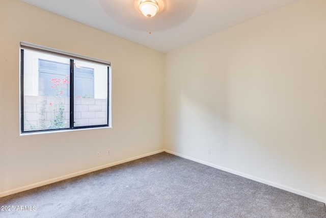 unfurnished room featuring ceiling fan and carpet