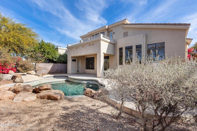 back of house with a patio and a balcony