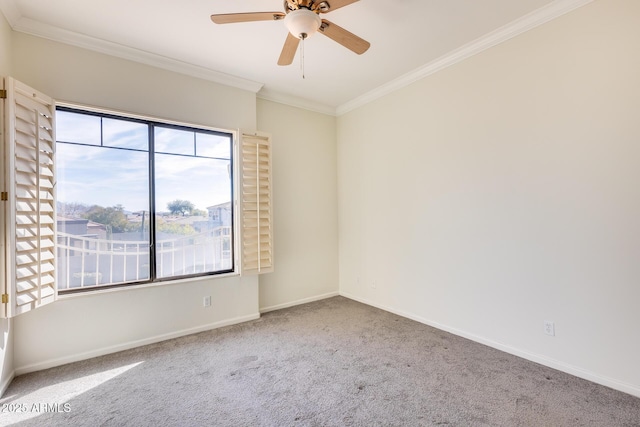 spare room featuring ceiling fan, ornamental molding, and carpet flooring