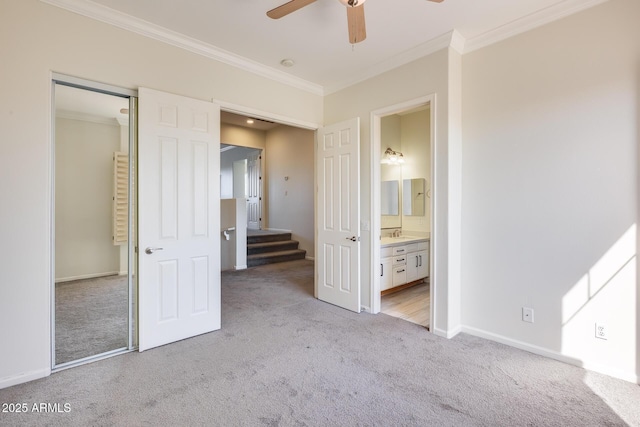 unfurnished bedroom with ornamental molding, ceiling fan, light carpet, ensuite bath, and a closet