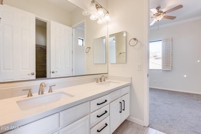 bathroom with ceiling fan, ornamental molding, and vanity