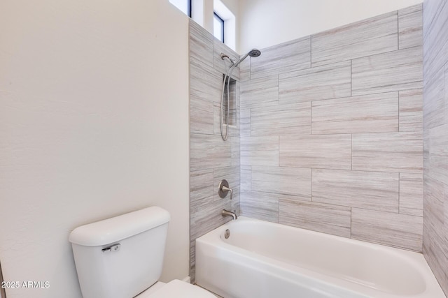 bathroom with toilet and tiled shower / bath combo