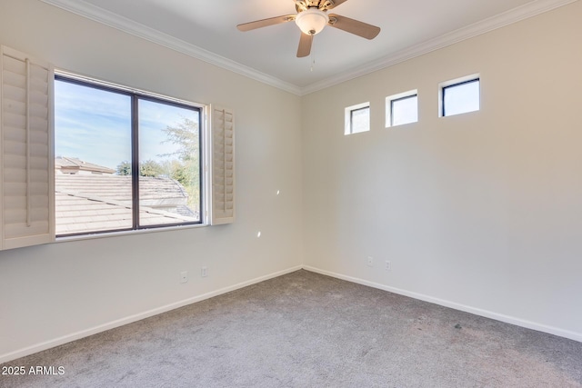 carpeted spare room with ornamental molding and ceiling fan