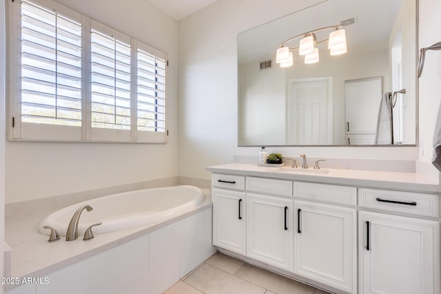 bathroom featuring a washtub, vanity, and tile patterned floors