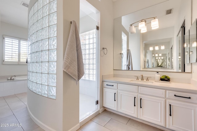 bathroom featuring tile patterned floors, plus walk in shower, vanity, and plenty of natural light