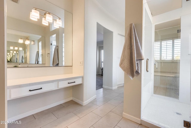 bathroom with tile patterned flooring, vanity, and a shower with shower door