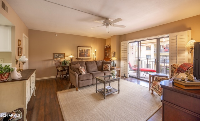 living room with ceiling fan and dark hardwood / wood-style floors