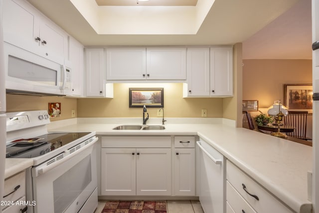 kitchen with white appliances, white cabinetry, and sink