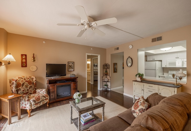 living room with hardwood / wood-style flooring and ceiling fan