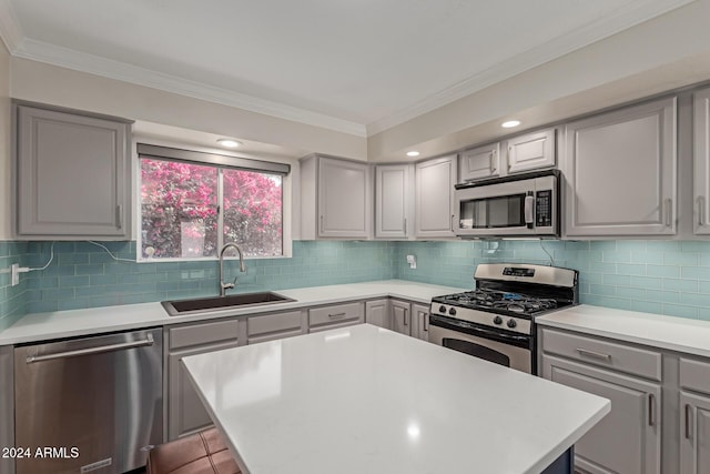 kitchen with gray cabinetry, sink, a center island, stainless steel appliances, and tasteful backsplash