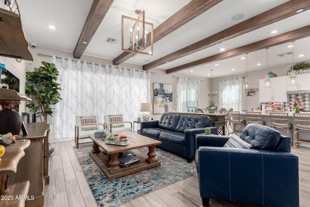 living room featuring light wood-style floors, beamed ceiling, visible vents, recessed lighting, and a chandelier