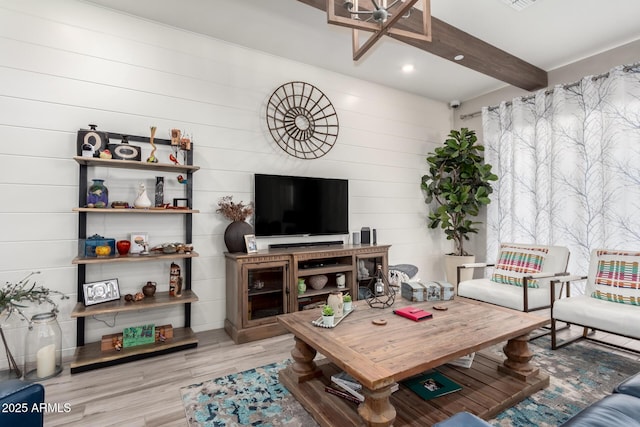 living room with recessed lighting, visible vents, beamed ceiling, and wood finished floors