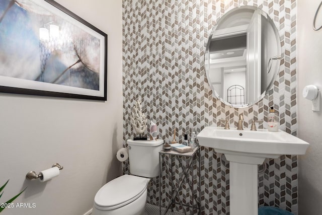bathroom featuring tile walls and toilet