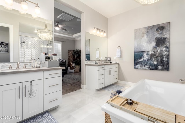 bathroom with ceiling fan with notable chandelier, two vanities, visible vents, a washtub, and a sink