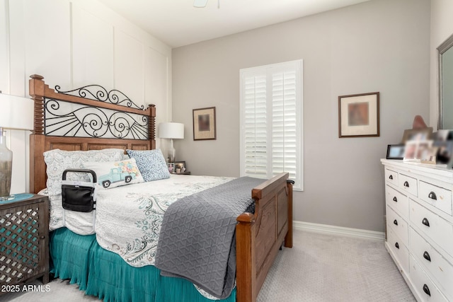 bedroom with baseboards and light colored carpet