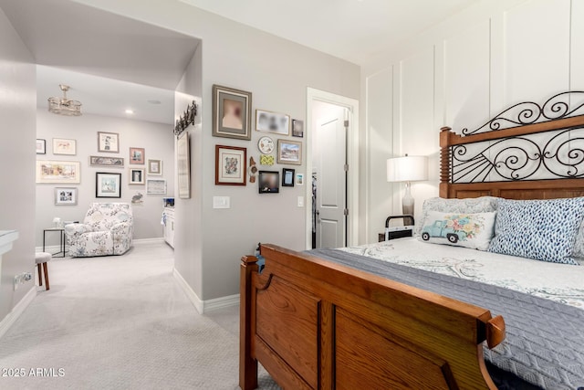 bedroom with baseboards and light colored carpet