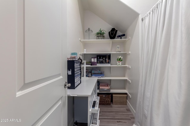 office area featuring wood finished floors, baseboards, and lofted ceiling