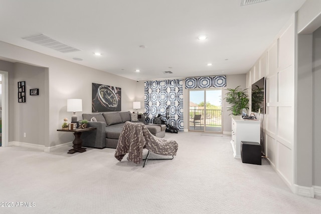 living area with light colored carpet, visible vents, and recessed lighting