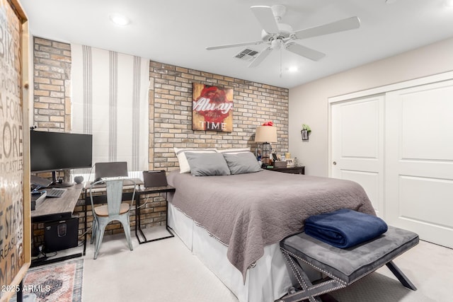 carpeted bedroom with a closet, brick wall, recessed lighting, visible vents, and ceiling fan