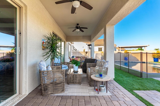 view of patio / terrace with outdoor lounge area, fence, and ceiling fan