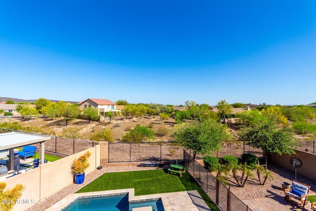 view of pool with a fenced in pool, a fenced backyard, and a lawn