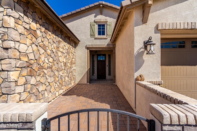 doorway to property with stucco siding and stone siding