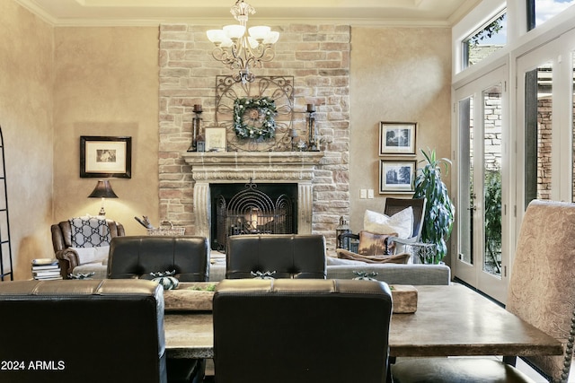 interior space with a stone fireplace, ornamental molding, and a notable chandelier