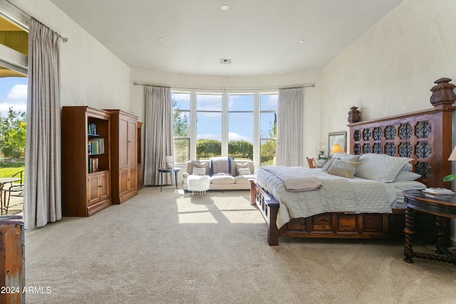 carpeted bedroom featuring access to outside and multiple windows