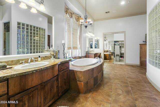 bathroom with vanity, crown molding, a relaxing tiled tub, a notable chandelier, and tile patterned flooring