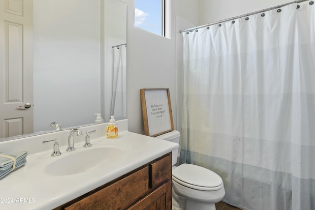 bathroom featuring vanity and toilet