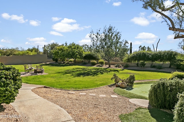 view of home's community with a patio area and a yard