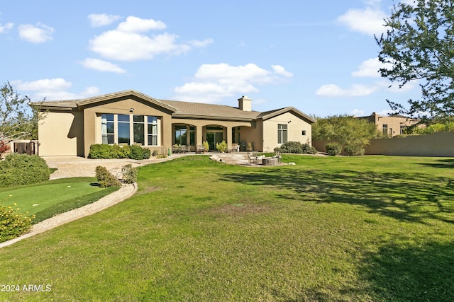 back of house with a yard and a patio