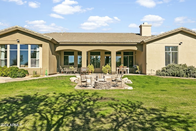 rear view of property with a patio area and a yard