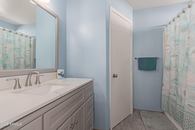 bathroom with vanity, hardwood / wood-style floors, and shower / bathtub combination with curtain