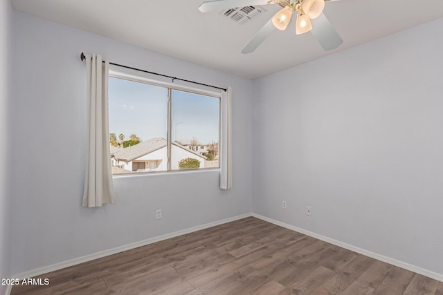 spare room with hardwood / wood-style floors and ceiling fan