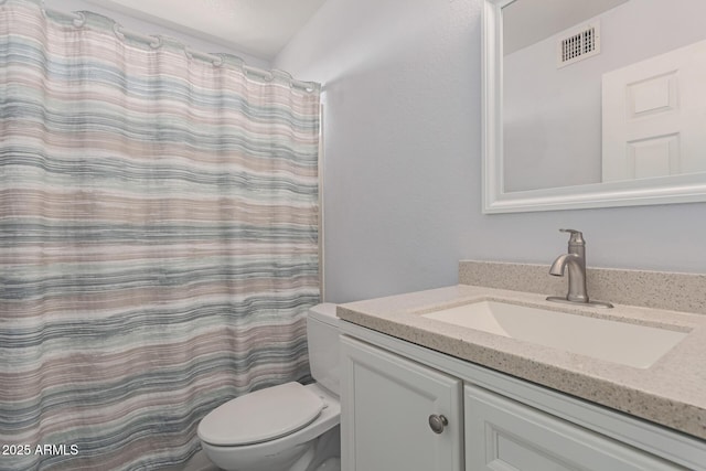 bathroom featuring vanity, curtained shower, and toilet