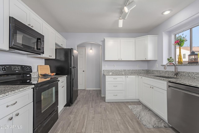 kitchen with white cabinets, sink, and black appliances