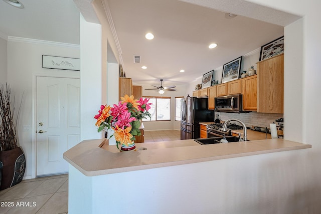 kitchen with visible vents, crown molding, appliances with stainless steel finishes, and backsplash