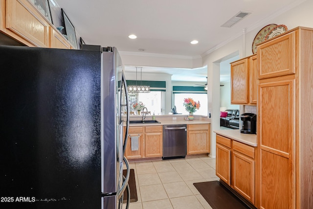 kitchen with light tile patterned floors, stainless steel appliances, a sink, visible vents, and crown molding