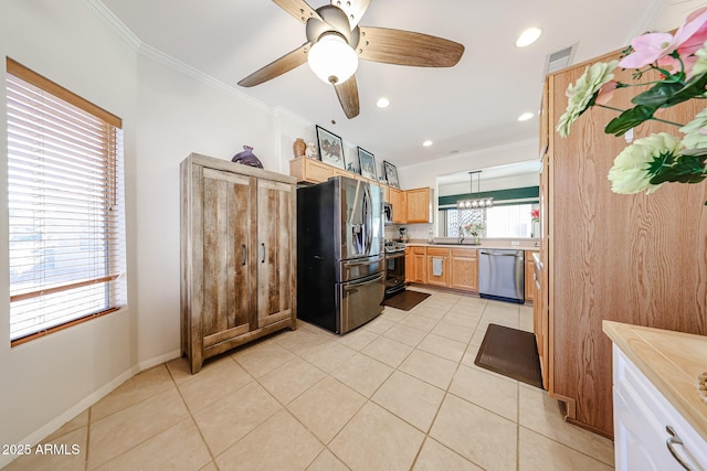 kitchen featuring stainless steel appliances, light countertops, crown molding, and light tile patterned floors