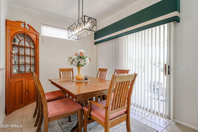 dining room featuring light tile patterned floors, ornamental molding, and a chandelier