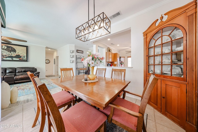 dining space with ornamental molding, visible vents, ceiling fan, and light tile patterned flooring