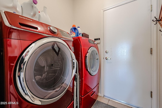 laundry room featuring laundry area, washer and clothes dryer, and tile patterned floors