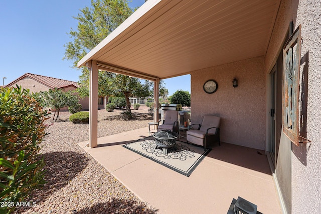 view of patio / terrace featuring an outdoor fire pit