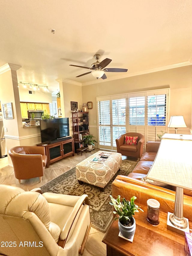 living room with crown molding, ceiling fan, and track lighting