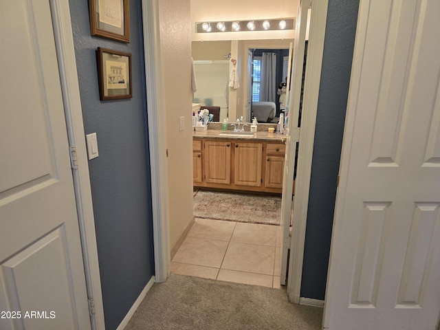 bathroom featuring tile patterned flooring and vanity