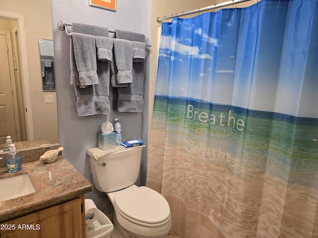 bathroom featuring vanity, a shower with curtain, and toilet