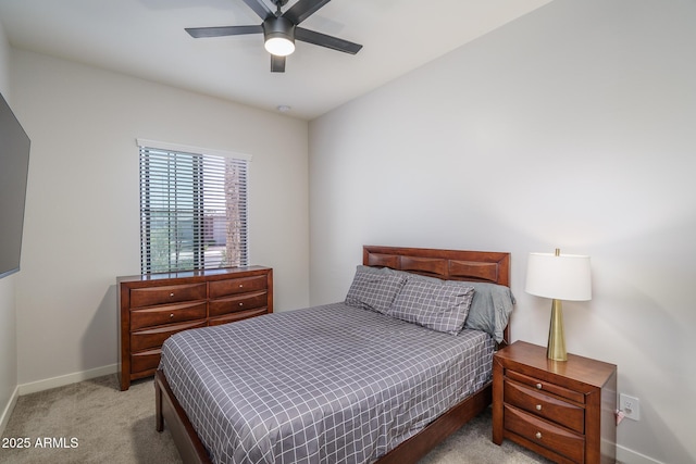 bedroom featuring baseboards, light carpet, and ceiling fan