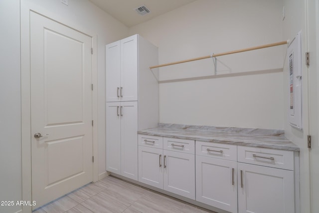 clothes washing area featuring visible vents